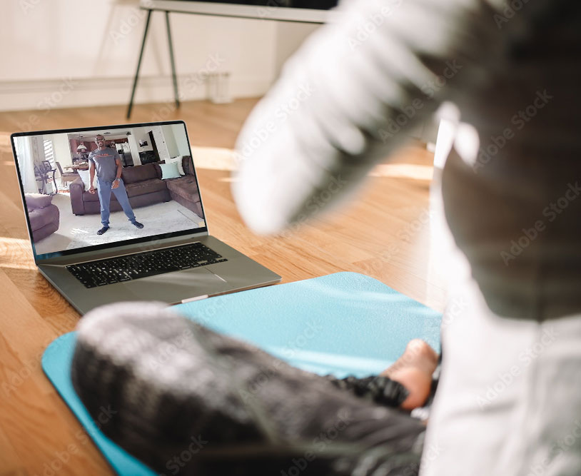 Individual on a mat watching Better Living personal training online video 